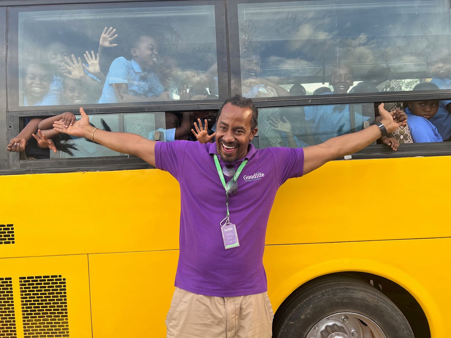 A Goodlife team member with schoolchildren on an outreach bus in Rwanda.